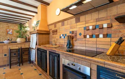 a large kitchen with a counter and a sink at Nice Home In Chiclana De La Fronter in Chiclana de la Frontera