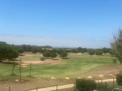 a view of a golf course with a green at Cadiz Golf & Beach in Barrio de Jarana