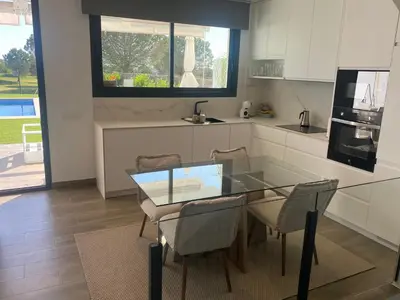 a kitchen with a glass table and some chairs at Cadiz Golf & Beach in Barrio de Jarana