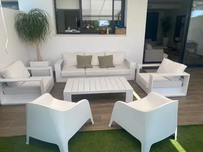 a living room with a white couch and chairs at Cadiz Golf & Beach in Barrio de Jarana