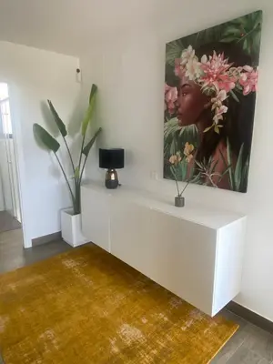 a living room with a painting on the wall at Cadiz Golf & Beach in Barrio de Jarana