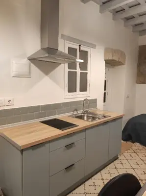 a kitchen with a sink and a stove at La Baraka Apartamentos 2 in Jerez de la Frontera