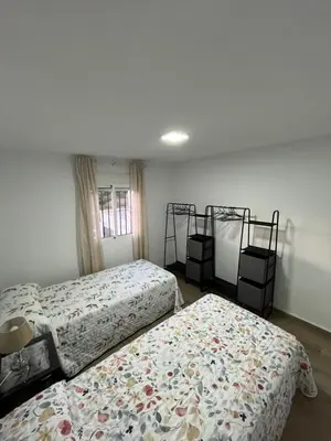 a bedroom with two beds and two bunk beds at Apartamento de Encanto in San Fernando