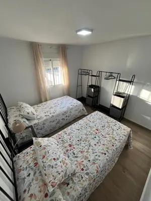 a bedroom with two beds and two bunk beds at Apartamento de Encanto in San Fernando