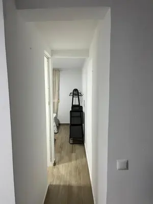 a hallway with a room with white walls and wood floors at Apartamento de Encanto in San Fernando