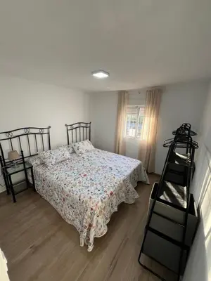a bedroom with a bed and a ladder in it at Apartamento de Encanto in San Fernando