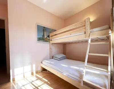 a bedroom with two bunk beds and a lighthouse at Villa Alegría in Roche