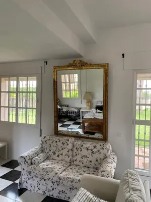 a living room with a couch and a mirror at Villa Alegría in Roche