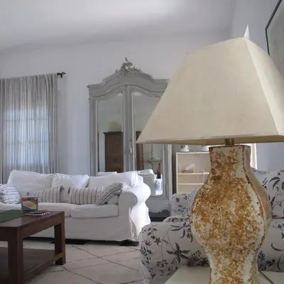 a living room with a lamp and a white couch at Villa Alegría in Roche