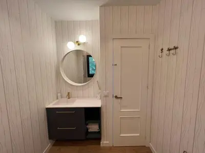 a bathroom with a sink and a mirror and a door at Sunset Villa Arcos in Arcos de la Frontera