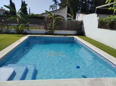 a small swimming pool with blue water in a yard at Sunset Villa Arcos in Arcos de la Frontera