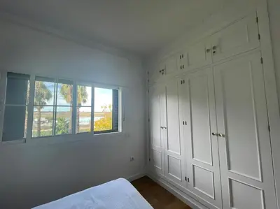 a white bedroom with a bed and a window at Sunset Villa Arcos in Arcos de la Frontera