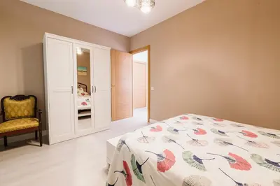 a bedroom with a bed and a chair at Precioso Chalet Atlántida solo familias in Roche