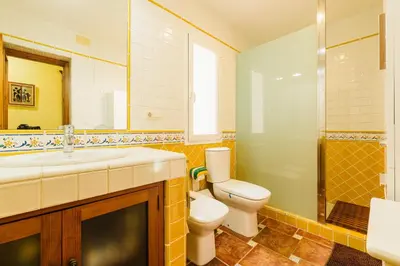 a bathroom with a toilet and a sink and a shower at Precioso Chalet Atlántida solo familias in Roche