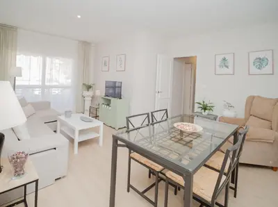 a living room with a glass table and a couch at Sibs Sanlucar Maestrante Centrico Ideal Familias in Sanlúcar de Barrameda