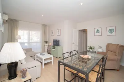 a living room with a couch and a table at Sibs Sanlucar Maestrante Centrico Ideal Familias in Sanlúcar de Barrameda