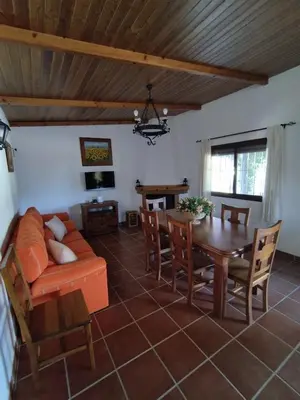 a living room with a couch and a table at Vivienda Rural Los Madroños in Malcocinado