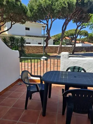 a blue table and chairs on a patio at Apartamento bajo Acuario in Chiclana de la Frontera