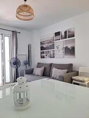 a living room with a couch and a table at Apartamento bajo Acuario in Chiclana de la Frontera