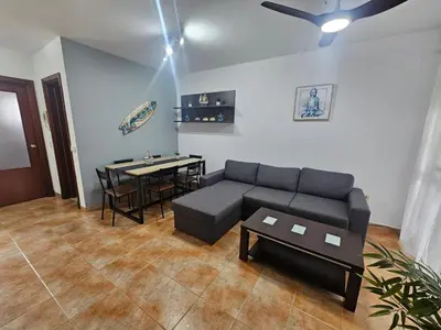 a living room with a table and a couch at VIÑAS DEL MAR-BALCONERA in Chiclana de la Frontera