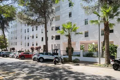 a row of cars parked in front of a building at Ancora - Piscina & Playa in El Puerto de Santa María