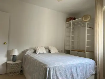 a bedroom with a bed with a blue bedspread at Ancora - Piscina & Playa in El Puerto de Santa María