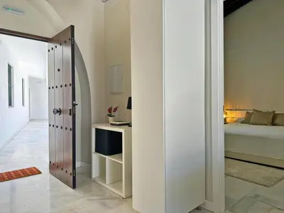 a bedroom with a bed and a door leading into a room at Apartamento El Tabanco - Ole Solutions in Jerez de la Frontera