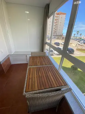 a bench in a room with a large window at Espectacular Valdemar in El Puerto de Santa María