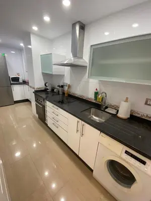 a kitchen with a sink and a washing machine at Espectacular Valdemar in El Puerto de Santa María