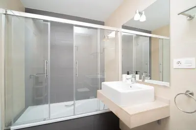 a bathroom with a white sink and a shower at Calma Beach Bajo de Guía in Sanlúcar de Barrameda