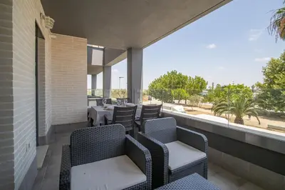 a patio with chairs and a table on a balcony at Calma Beach Bajo de Guía in Sanlúcar de Barrameda