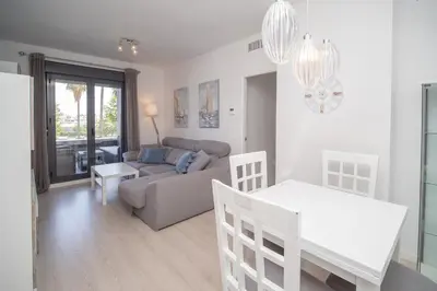 a living room with a couch and a table at Calma Beach Bajo de Guía in Sanlúcar de Barrameda