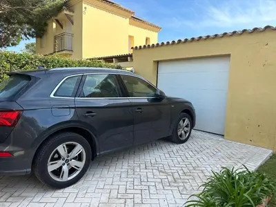 a black car parked in front of a garage at Villa Loma Cris y Javi in Cádiz