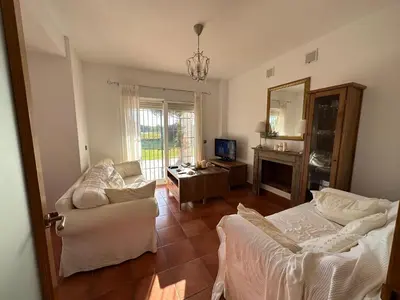 a living room with a couch and a table at Villa Loma Cris y Javi in Cádiz