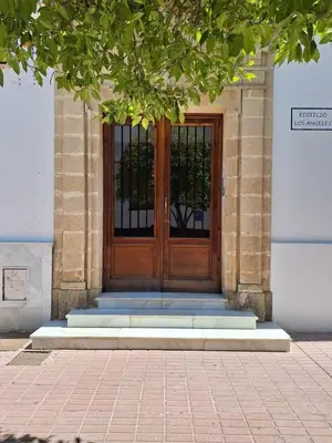 a wooden door on a building with blue steps at Cabildo Plaza 1 Sanlúcar de Barrameda in Sanlúcar de Barrameda