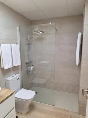 a bathroom with a glass shower with a toilet at Cabildo Plaza 1 Sanlúcar de Barrameda in Sanlúcar de Barrameda