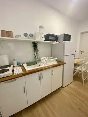 a kitchen with white cabinets and a counter top at Acogedora casa de invitados con piscina 1 in El Puerto de Santa María