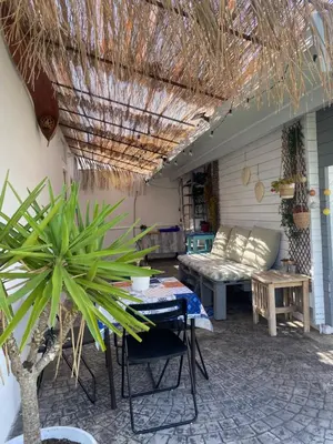 a patio with a couch and a table at Acogedora casa de invitados con piscina 1 in El Puerto de Santa María