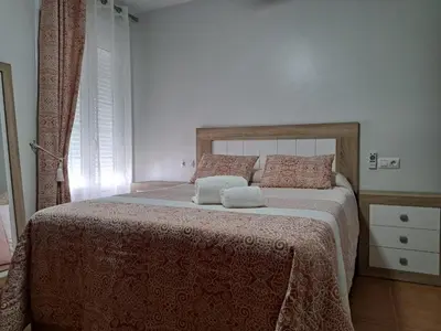 a bedroom with a bed with two pillows on it at La Cuesta in Medina Sidonia