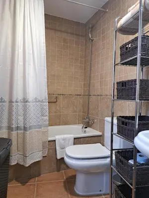a bathroom with a toilet and a tub and a shower at La Cuesta in Medina Sidonia