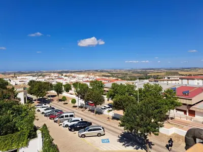 an aerial view of a parking lot with cars at La Cuesta in Medina Sidonia