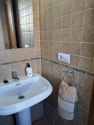 a bathroom with a white sink and a mirror at La Cuesta in Medina Sidonia