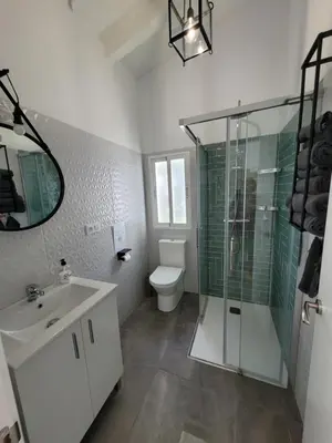 a bathroom with a sink and a shower and a toilet at Casa Felicidad in Chiclana de la Frontera
