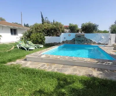 a swimming pool in the backyard of a house at Casa Felicidad in Chiclana de la Frontera