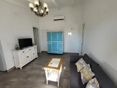 a living room with a couch and a table at Casa Felicidad in Chiclana de la Frontera