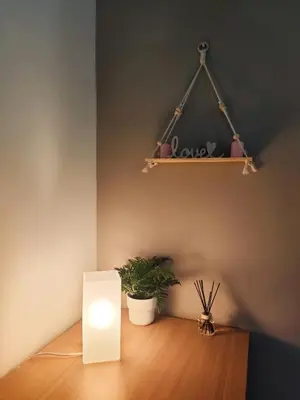 a room with a table with a light and a plant at Brisa del Mar in Chiclana de la Frontera