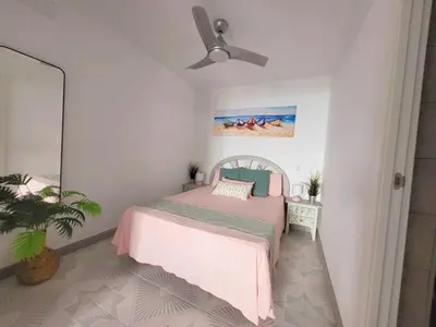 a bedroom with a bed and a ceiling fan at Brisa del Mar in Chiclana de la Frontera