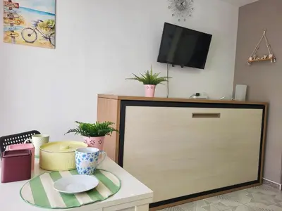 a cabinet with a television on top of it at Brisa del Mar in Chiclana de la Frontera