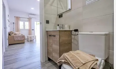 a bathroom with a sink and a toilet in a room at Ohana in Conil de la Frontera