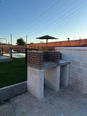 an umbrella sitting on top of a brick wall at Ohana in Conil de la Frontera